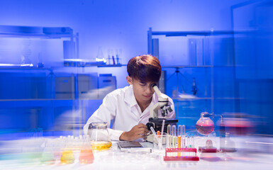 Young Scientist Engaged in Research with Microscope in Laboratory
