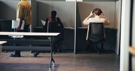 Workflow, cubicle and business people coworking in office with headphones, data or document. Shared workspace, group or productivity in company with back view, busy or efficiency with finance workers