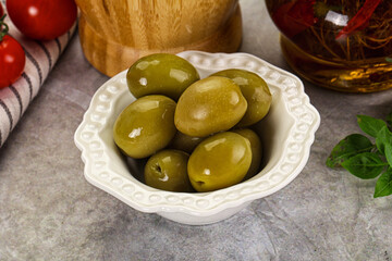 Big green marinated olives in the bowl