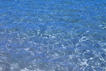 Obraz premium Surface of Clear Deep Blue Red Sea Water with Sunlight Reflections and Underwater Ripples