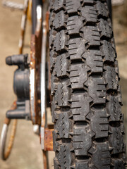 an old and Vintage motorbike tire showing tread and rust