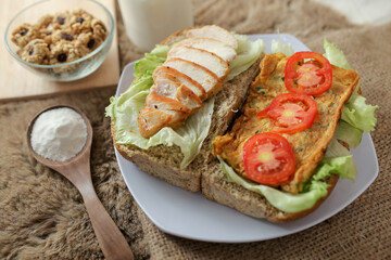 Big breakfast, bread, chicken slice, tomato, lettuce, smoked beef, egg, salad with milk. Bread sandwich fresh and healthy food meal lunch dinner breakfast slices of sandwiches.