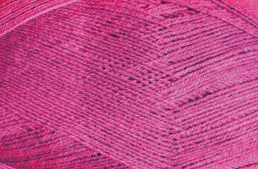 The texture of the pink yarn shows off the tightly twisted threads.