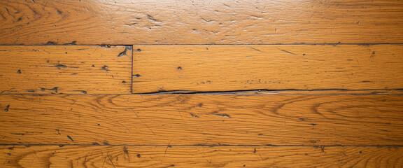 Fototapeta premium Friction lines, small notches, and uneven color tones bring authenticity to this unrefined wooden plank surface.