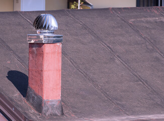 Metal Turbine Vent on Red Waterproofed Roof of European House