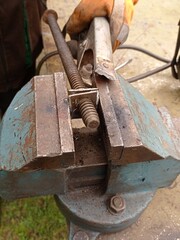 Close up of a person using an anvil for metal work.
