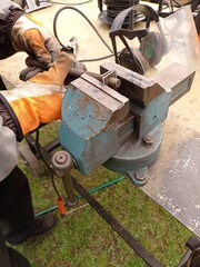 Close-up of a person doing metal work with an anvil.