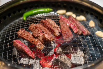 Sirloin Hanwoo Beef, marbled Korean Style Meat on the Grill. BBQ rare meat with soft focus