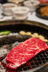 Sirloin Hanwoo Beef, marbled Korean Style Meat on the Grill. BBQ rare meat with soft focus
