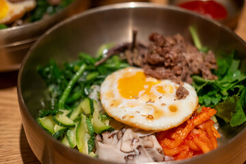 Bibimbap, a Korean rice dish. It is cooked rice mixed with namul, gochujang, egg and meat.
