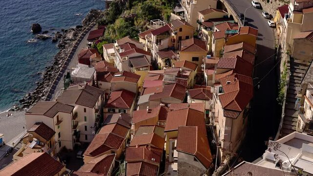 Aerial view of Scilla, a charming village in Calabria, Southern Italy, featuring its terracotta rooftops and coastal road