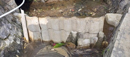 Small Stream with Makeshift Dam and Concrete Banks