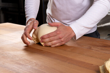 Pastry chef kneads puff pastry.