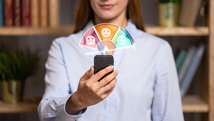 Woman Holding Smartphone Showing Customer Feedback Emojis