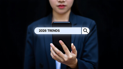Woman in Blue Blazer Searching 2026 Trends on Smartphone