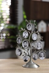 Family tree photo frame on wooden table indoors