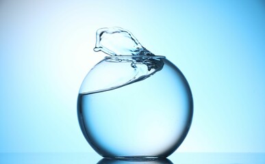 Glass aquarium with water on light blue background
