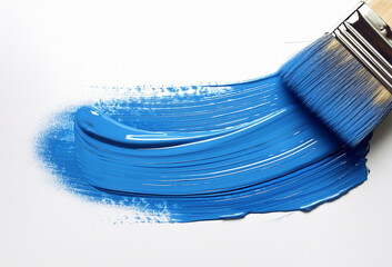 A wide paintbrush glides across a white surface, leaving behind a smooth, vibrant streak of rich blue paint in an expressive, textured stroke.