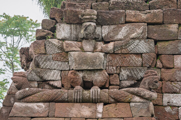 Closeup view of garuda on naga stone carving in ancient Candi Sukuh hindu temple gate, Karanganyar,...