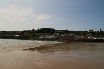beautiful ardmore beach in ireland county waterford on a sunny day with view to the village