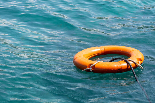 Lifebuoy floats on the ocean. Security concept.