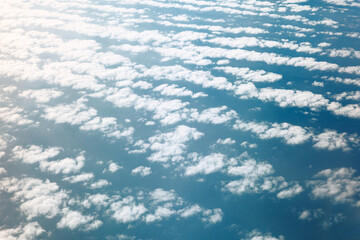 Soft white clouds drifting serenely across a deep blue backdrop. Sea of clouds, a vast expanse of...