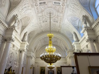 A wide-angle, eye-level perspective captures the majestic interior of a historic palace hall,...