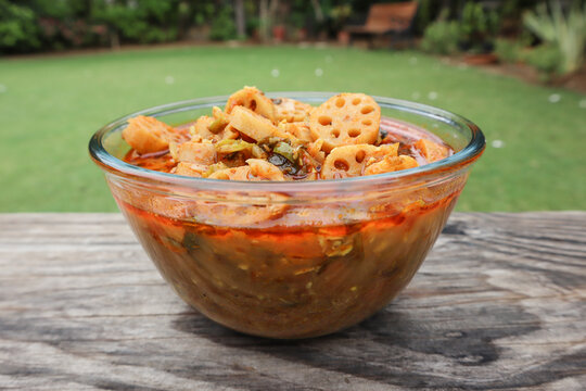 Side view of Kamal kakadi or Lotus stem curry. Lotus stem food homemade served in transparent bowl with nature background