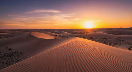 Beautiful desert landscape with undulating sand dunes under a vibrant sunset sky at golden hour