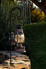 Unlit antique oil lamp hanging at dusk