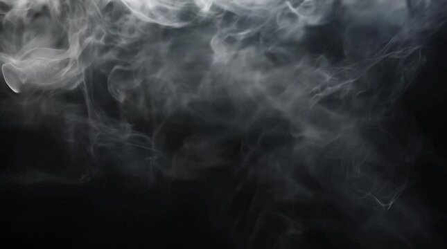 Swirling white smoke on dark background creating abstract floating shapes and atmospheric effect.