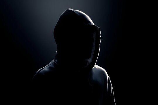 Mysterious shadowy figure in a stark hoodie exudes enigmatic allure.