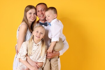 Happy family on yellow background. Space for text