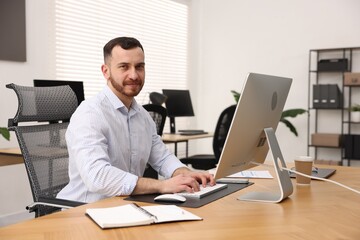 Man working on computer at desk in office