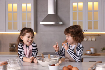 Cooking recipe. Little children making dough for cookies at table in kitchen