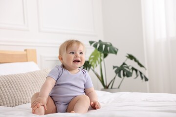 Fototapeta premium Cute little baby on bed at home, space for text