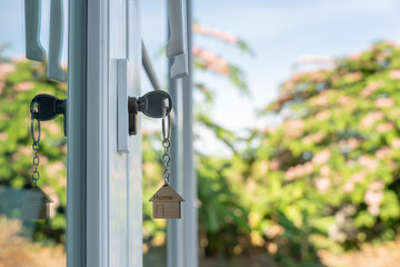 unlocking house is plugged into the door. Second hand house for rent and sale. keychain is blowing...