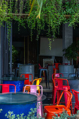 Colorful outdoor cafe with vibrant chairs and greenery