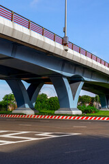 Urban overpass with clear blue sky and ferris wheel in the background