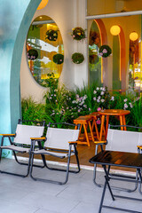 Modern outdoor cafe with contemporary decor and vibrant hanging plants