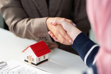 Real Estate Agreement. Two professionals shaking hands over a property deal.