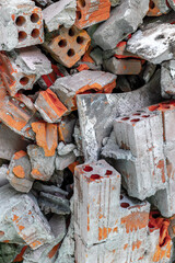 Pile of broken red and gray bricks and debris