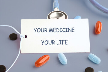 The conceptual phrase is YOUR MEDICINE YOUR LIFE. Invest in your health Concept.