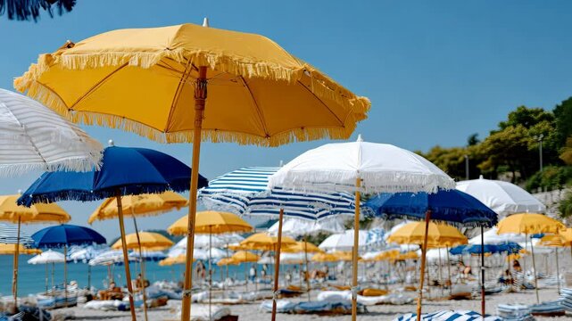 Vibrant beach umbrellas create a lively atmosphere at a sunny waterfront location filled with visitors enjoying summer activities