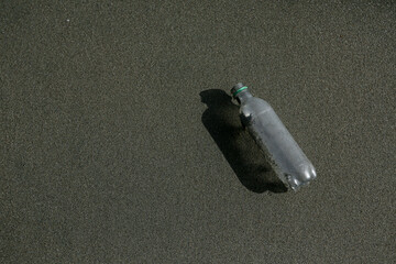 Abandoned Plastic Bottle on the Beach Sand