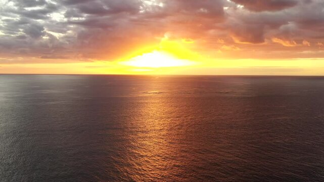Bright setting sun over Pacific ocean horizon off Tokoriki resort island at Fiji as 4k.
