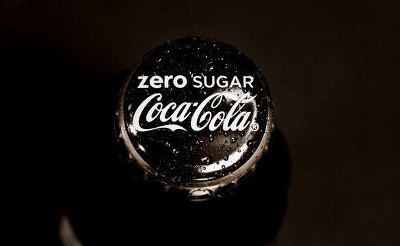 Classic black zero sugar Coca-Cola Bottle Cap lid, with water Drops, top view. Zero Coca-Cola is One of the Popular Refreshing Drinks for no calories intake.