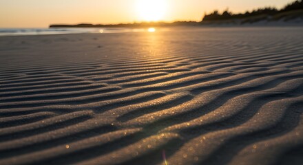 Fototapeta premium Beautiful sunset paints the beach with warm hues, as waves gently kiss the sand under a vibrant sky, reflecting the sun's descent over the tranquil ocean