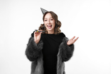 Birthday celebration. Woman with party horn on white background