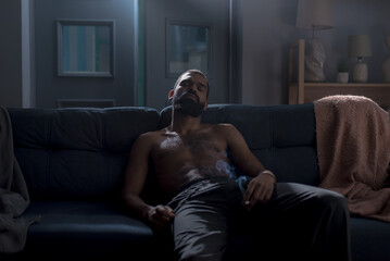 African American man calms down after stressful situation on couch